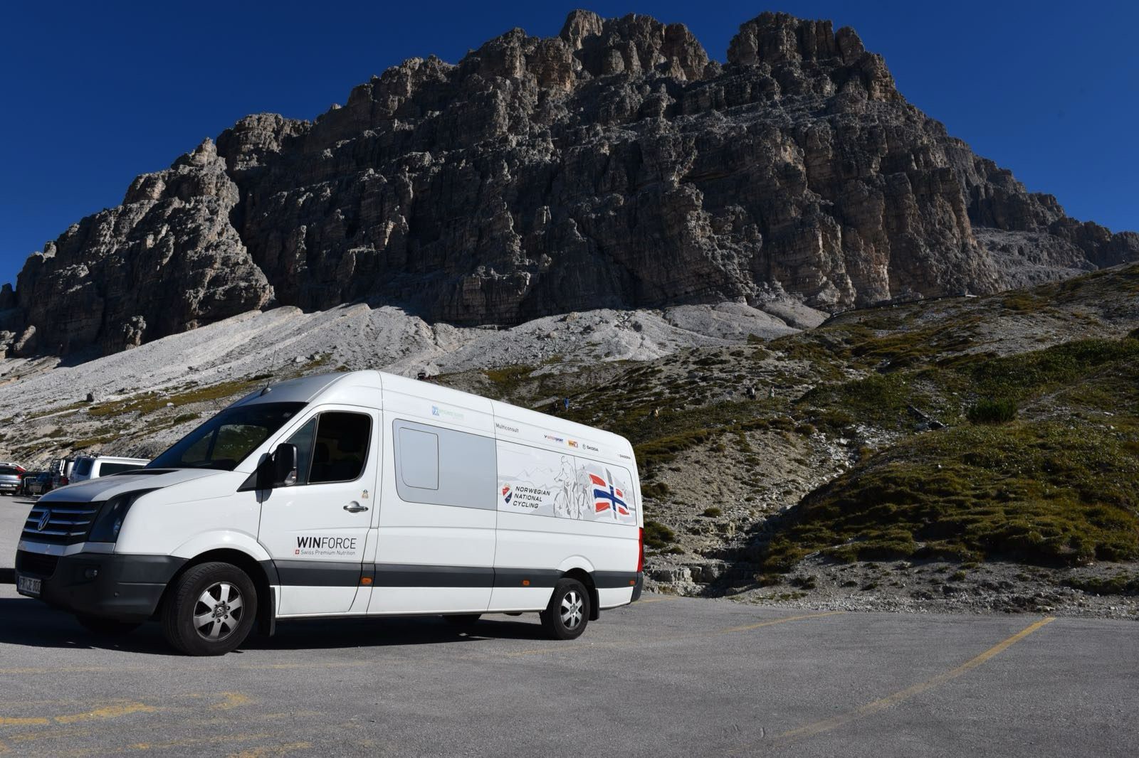 Team vehicle in front of the Dolomites